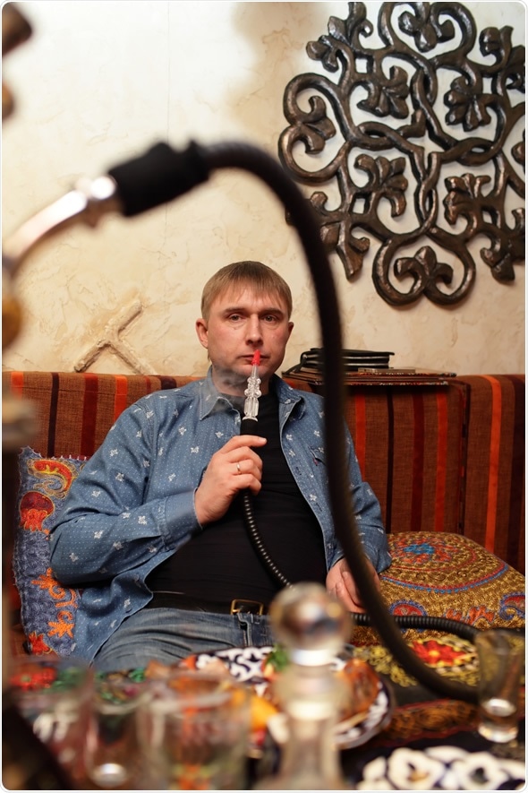 Man smoking nargile in the asian restaurant