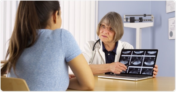 Senior doctor reviewing woman Senior doctor reviewing woman