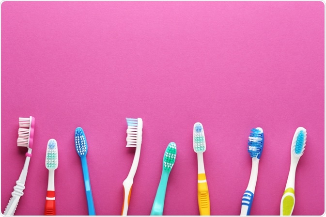 Picture of various types of toothbrushes in a line, on a pink background - picture taken by 5 second Studio Picture of various types of toothbrushes in a line, on a pink background - picture taken by 5 second Studio