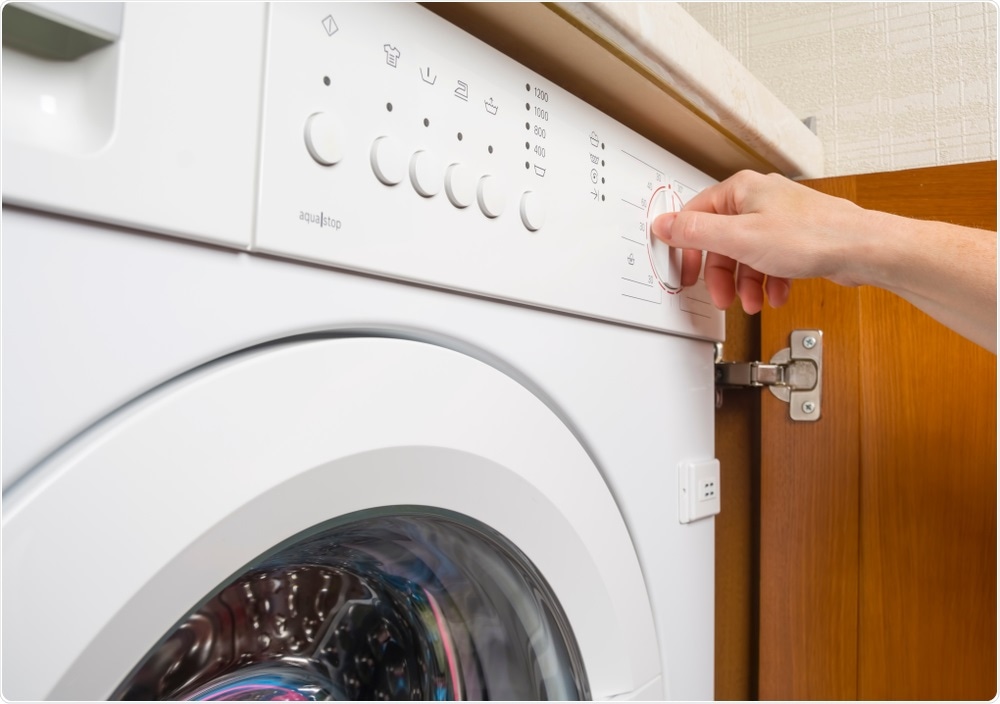 Person using washing machine