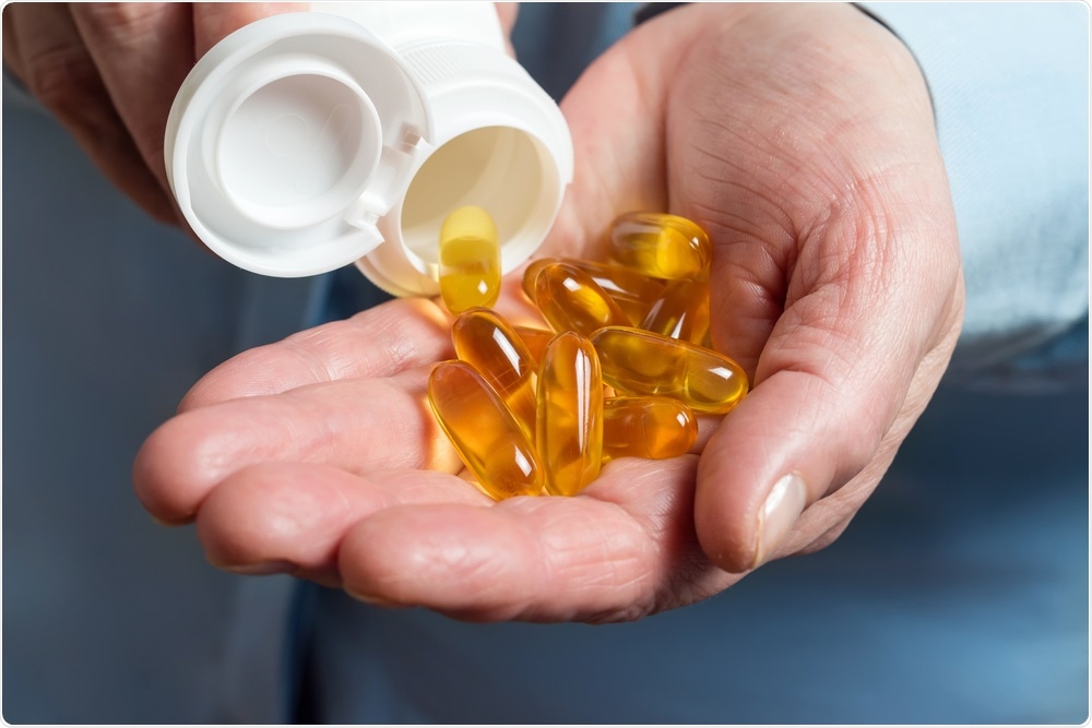 Man taking omega-3 supplements
