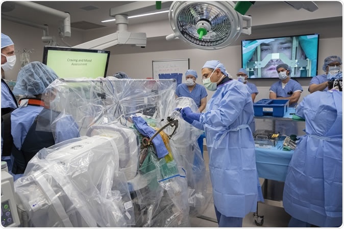 WVU Medicine Dr. Ali Rezai, executive chair of the Rockefeller Neuroscience Institute, asks questions and receives answers from DBS patient Gerod Buckhalter. The answers guide adjustments to the DBS implant. November 1, 2019. (WVU Photo/Greg Ellis)