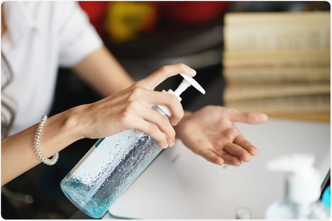 Woman using hand sanitizer Woman using hand sanitizer
