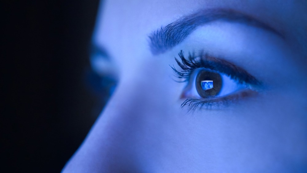 Close-up of beautiful young woman eyes looking at monitor, working with computer, laptop. Monitor blue light is reflected in her eyes. Image Credit: Youproduction/Shutterstcock.com