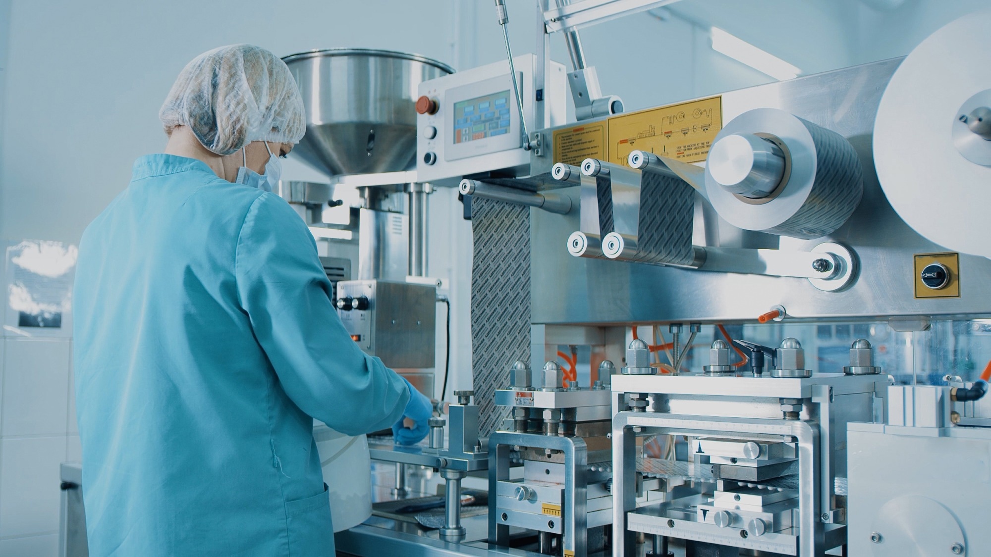 4K Blister Packing Machine. Woman works at the workplace.