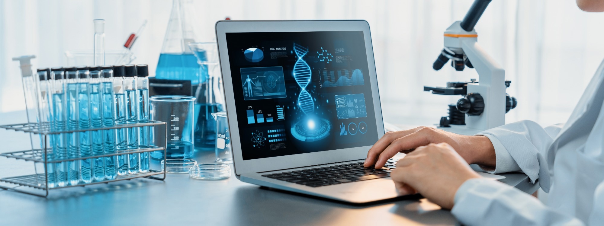 Scientist working on advance biotechnology computer software to study or analyze DNA data after making scientific breakthrough from chemical experiment on medical laboratory.
