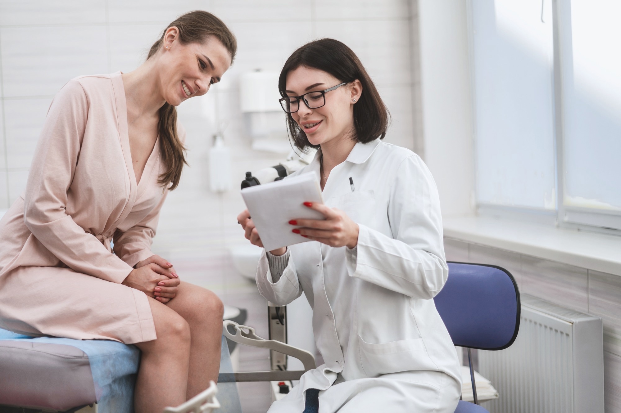 woman doctor look microscope at gynecologist