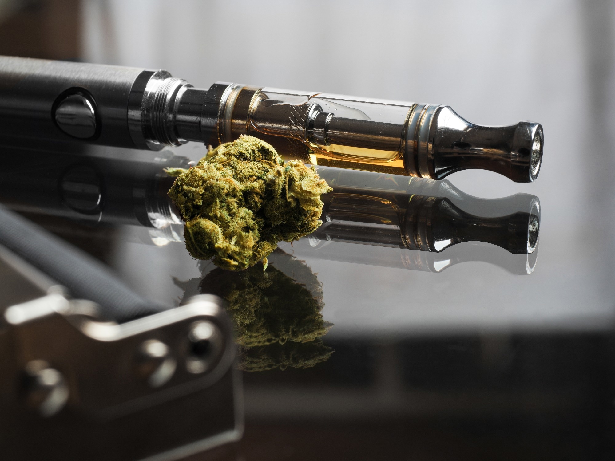 Close up shot focus stack of real cannabis or weed and vape pen in the background